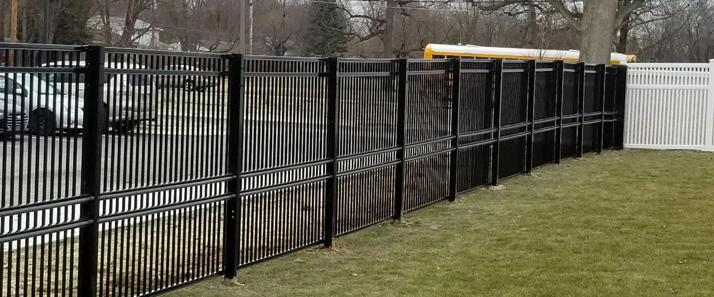 commercial parking lot with black metal fence Indianapolis IN
